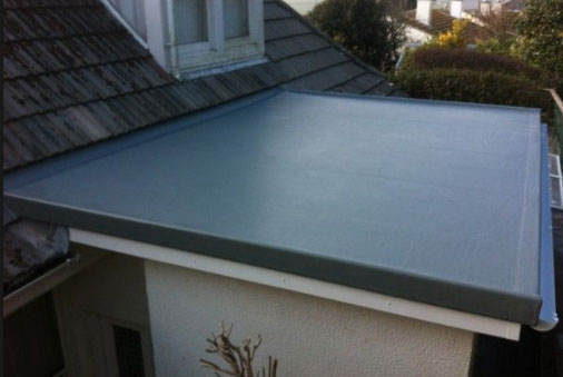 A roof with a blue tarp on top of it.