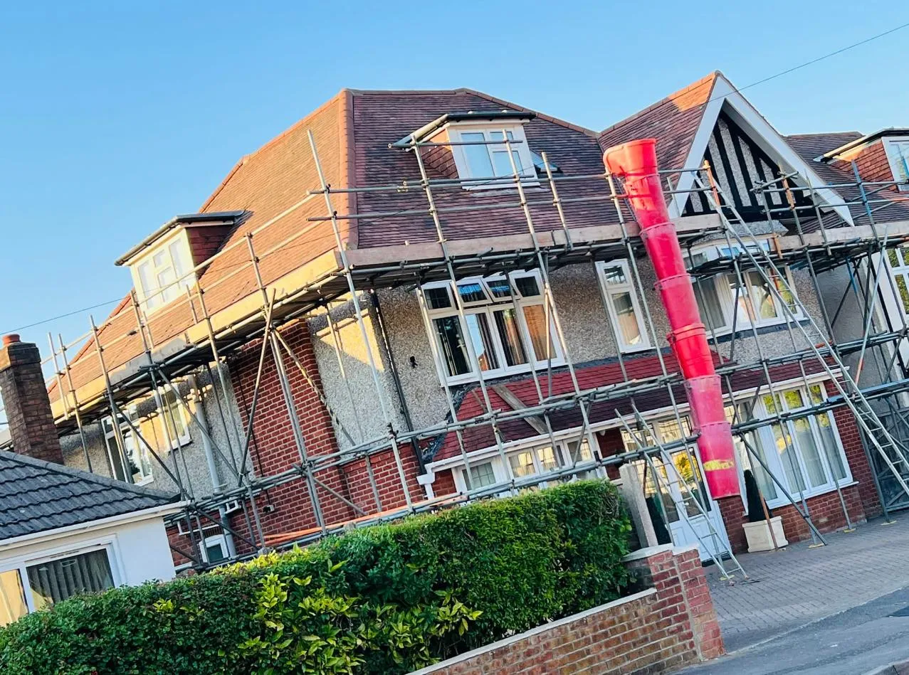 A row of houses with scaffolding on top of them.