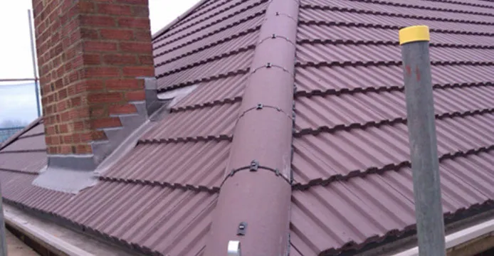 A red brick building with a metal roof.